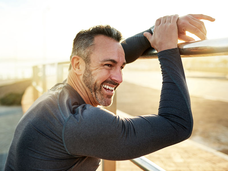 older man enjoying a view after a run